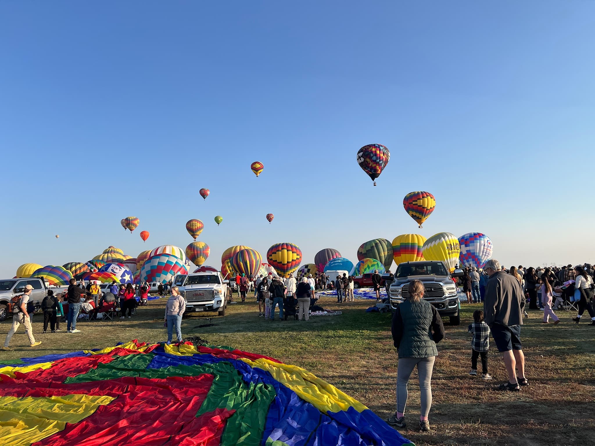 Guests standing beside an inflated balloon envelope before a flight